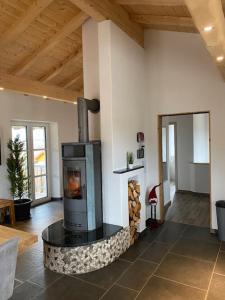 a living room with a wood stove in a room at Allgäu-Chalet Kaufbeuren in Kaufbeuren