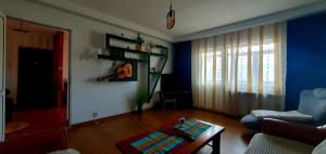 a living room with a couch and a table at Mândra Apartaments in Curtea de Argeş