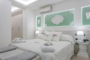Postel nebo postele na pokoji v ubytování Boutique Hotel Paradiso Bovelacci
