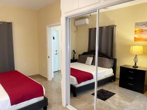 a bedroom with two beds and a mirror at Sea-Renity in Philipsburg