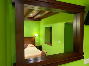 A bed or beds in a room at Hotel El Quintanal