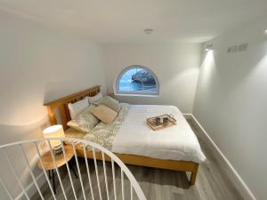 a bedroom with a bed with a window at Unique Waterfront Duplex on the Mediterranean - Caleta, Catalan Bay in Gibraltar