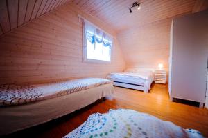 a room with two beds and a window at CUBA domki letniskowe in Sarbinowo
