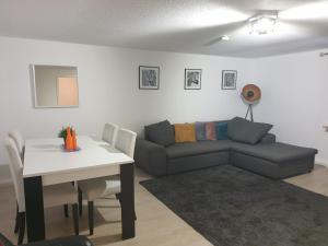 a living room with a couch and a table at Stylish accommodation in the middle of Wiesbaden in Wiesbaden