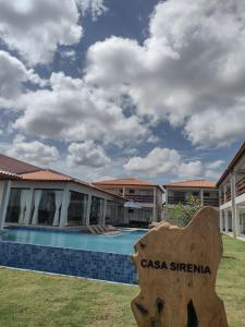 a resort with a swimming pool in front of a building at Casa Sirenia in Cajueiro