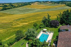 an overhead view of a swimming pool in a field at Villa Peyrigué in Seysses-Savès