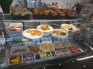 a display case filled with lots of different types of food at South Lake House - 300m to South Lake Leisure Centre in Derrymacash