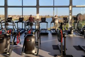 a gym with several people exercising on tread machines at South Lake House - 300m to South Lake Leisure Centre in Derrymacash