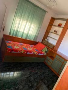 a bedroom with a bed and a window at COCO in Puerto del Rosario