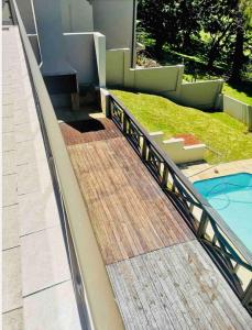 a staircase leading to a house with a swimming pool at Ndaba Golf Lodge on 13th hole in East London