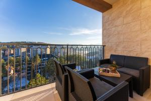 a patio with a table and chairs on a balcony at Apartment Papillon 5 in Zlatibor