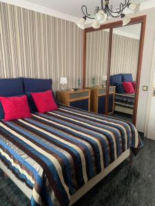 a bedroom with a large bed with red and blue pillows at COCO in Puerto del Rosario