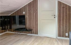 an empty room with a door and wooden walls at Amazing Home In Brttum With House A Panoramic View in Skrukkerud