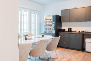 a kitchen with a table and chairs in a room at Buer Appartment in Gelsenkirchen