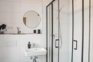 a bathroom with a shower and a sink and a mirror at Buer Appartment in Gelsenkirchen