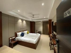 a hotel room with a bed and a television at Five Elements in Visakhapatnam