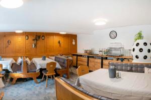 a restaurant with tables and chairs and a kitchen at Pension Grünwald in Sölden