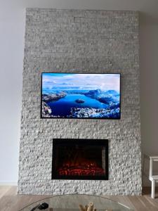 a fireplace with a tv on top of it at Divernoa Mountain Bjelašnica in Bjelašnica