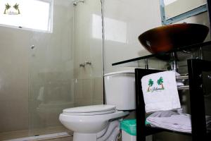 a bathroom with a toilet and a glass shower at Centro Vacacional Las Palmas in San José del Guaviare