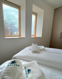 a bedroom with two beds with towels on them at Randevu Nivalis in Jahorina
