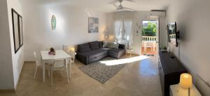 a living room with a couch and a table at Casa Lovia in Orihuela Costa