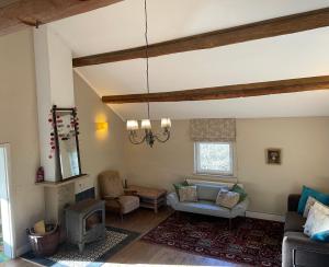 a living room with a couch and a fireplace at La Bruyere du Coq Stables in Sart-Dames-Avelines