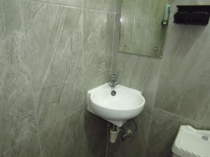 a bathroom with a white sink and a mirror at Cozy 1 bed Apt 2B in Rockley near American Embassy in Bridgetown +17 photos