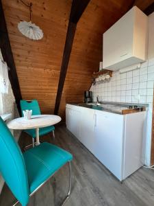 a kitchen with a table and chairs and a counter at Haus Friesenjungs in Böhl