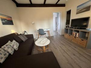 a living room with a couch and a table at Haus Friesenjungs in Böhl
