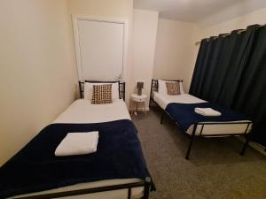 a room with two beds and a window in it at The Grove House with Free Parking in Hull
