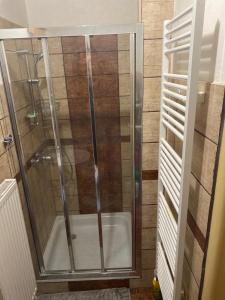 a shower with a glass door in a bathroom at Ubytovanie u Katky in Bobrovec