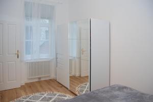 a room with a mirror and a white cabinet at Pink Lotus Apartment in Vienna