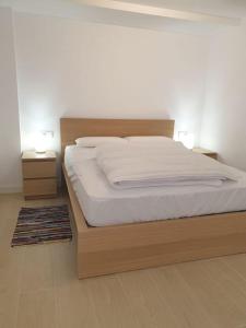 ein Bett in einem Schlafzimmer mit zwei Nachttischen und zwei Lampen in der Unterkunft Casa cariño in Alicante