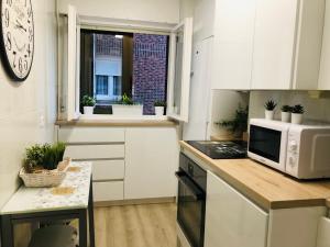 uma cozinha com um micro-ondas e uma bancada em Precioso apartamento en Los Castros em Santander