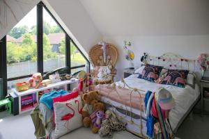 a bedroom with a bed with stuffed animals on it at Hurstpierpoint 3 bedroom House with Hot-Tub & Garden in West Sussex in Hurstpierpoint