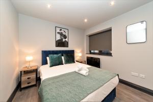 a bedroom with a large bed and a television at King Size Bed Super Morden One Bedroom Flat next to Seafront in Brighton & Hove