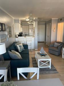 a living room with a blue couch and a table at Hilton Head Resort in Hilton Head Island