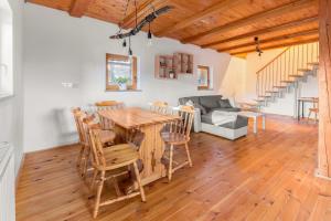 a living room with a wooden table and chairs at Svisla in Kranj