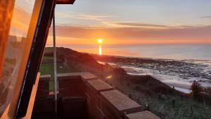 a view of the ocean at sunset from a train at Coastguard Lookout in Hunstanton
