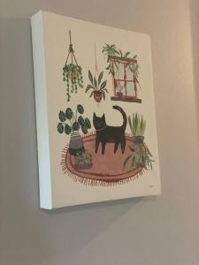 a picture of a black cat in a pot of plants at Casa Mezquite. In Downtown Brownsville in Brownsville