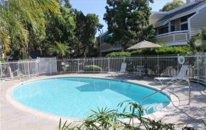 a swimming pool in a yard with a fence at King.Queen-2 mins to South coast Plaza in Santa Ana