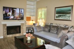 a living room with a couch and a fireplace at King.Queen-2 mins to South coast Plaza in Santa Ana