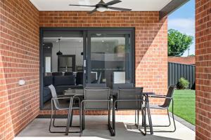 a patio with chairs and a ceiling fan at Julie-Anna, Bendigo in Bendigo