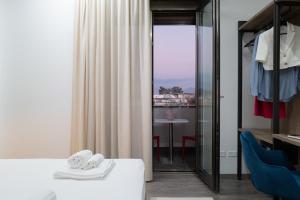 a bedroom with a bed and a view of a table at MyHouse Pompei in Pompei