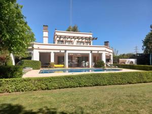 a house with a swimming pool in front of it at Calma Vistalba in Ciudad Lujan de Cuyo