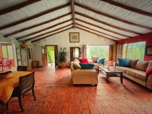 a large living room with couches and a table at Finca Agrreste in Nemocón