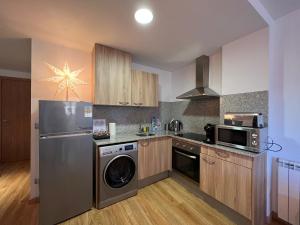 a kitchen with a refrigerator and a dishwasher at Apartamento Premium en Ribasol Ski & Mountain Park in Arinsal