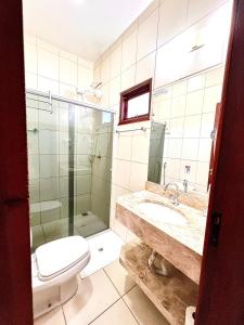 a bathroom with a toilet and a sink and a shower at Pousada Remanso in Bonito