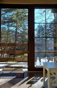 a room with two large glass doors and a table at Vila Lucic Zlatibor in Zlatibor
