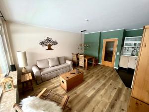 ein Wohnzimmer mit einem Sofa und einem Tisch in der Unterkunft Mountain Lodge in Sankt Andreasberg